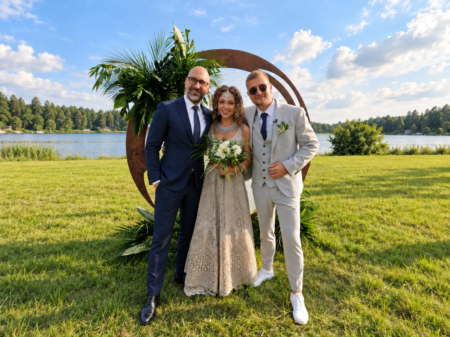 Newlyweds and event host in a garden